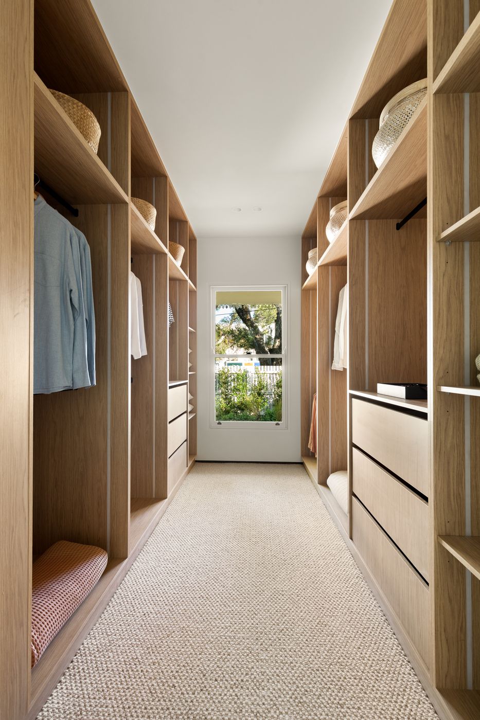 Oak walk-in robe leading to a sash window