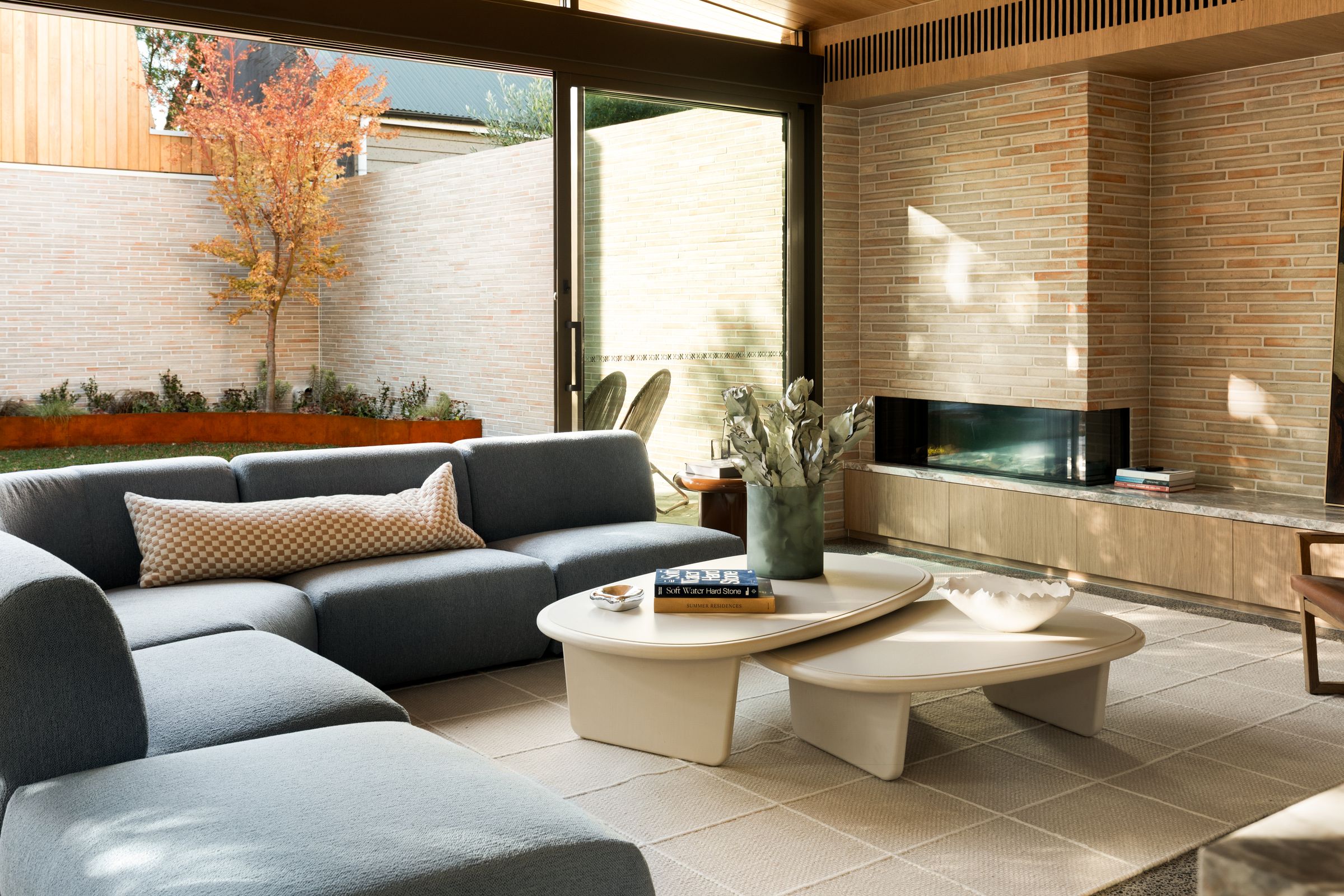 Living room and kitchen opening to the garden through corner glazing
