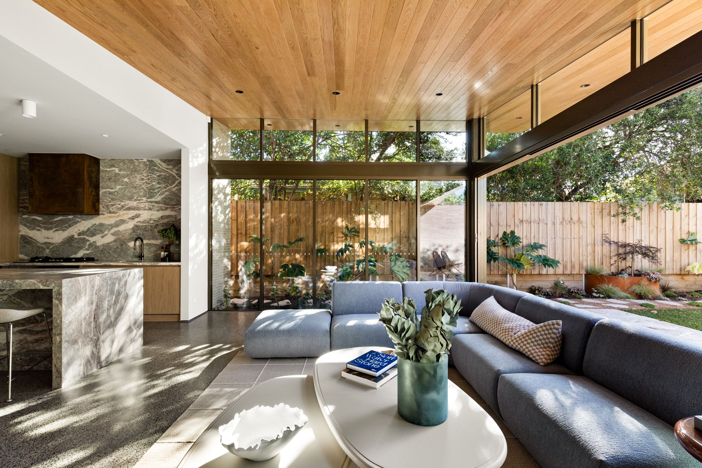 Marble island and dining table leading to the living room and garden