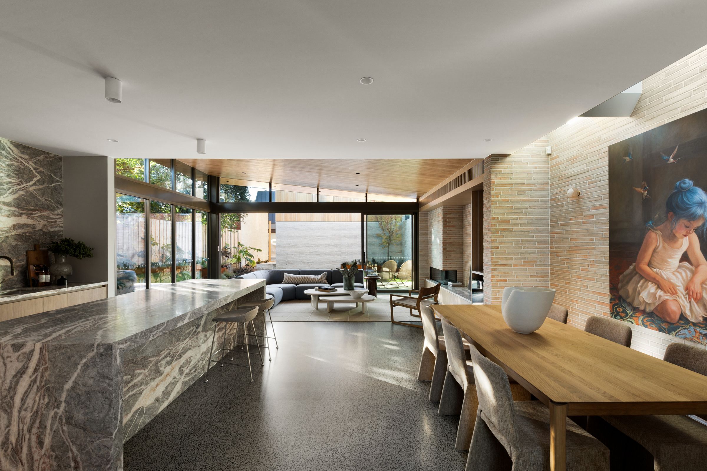 Balston marble kitchen island looking through the dining area to the living room and garden