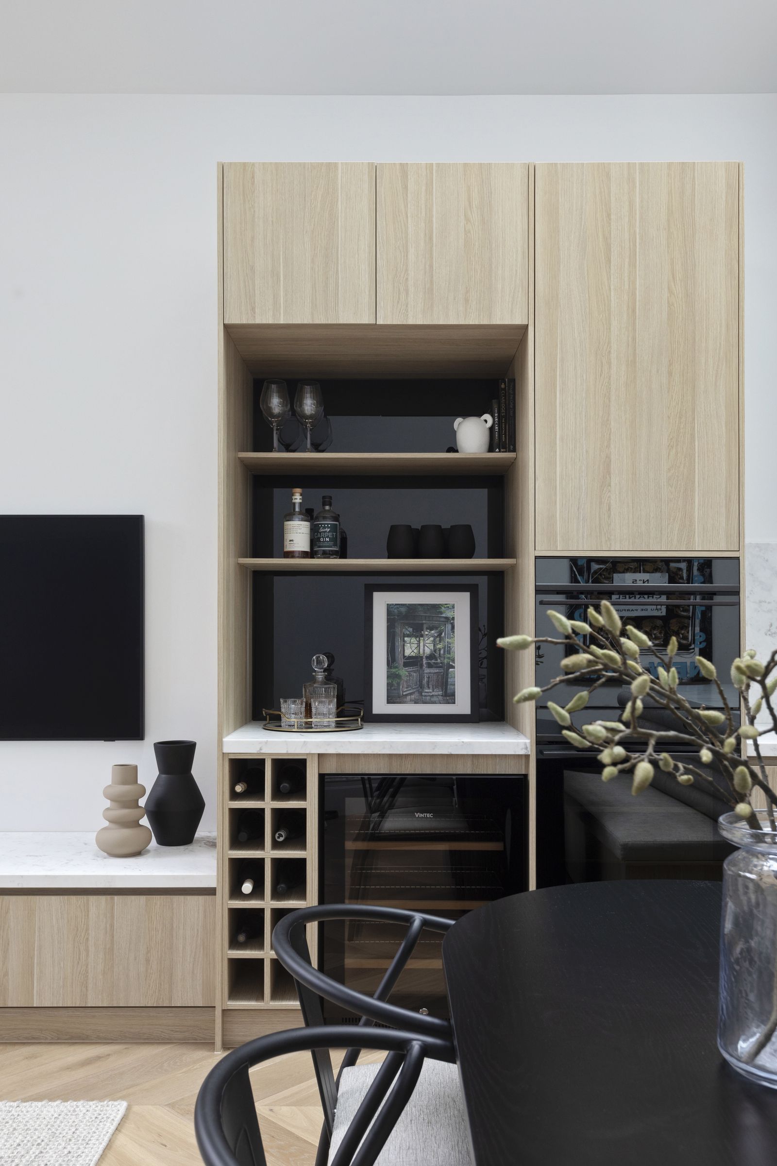 Bar joinery in pale oak with open shelving, marble benchtop and wine storage